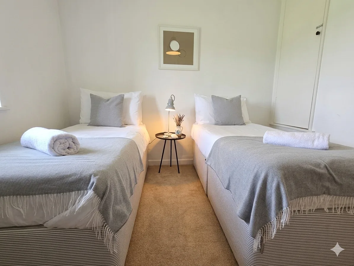 Twin bedroom with soft grey furnishings