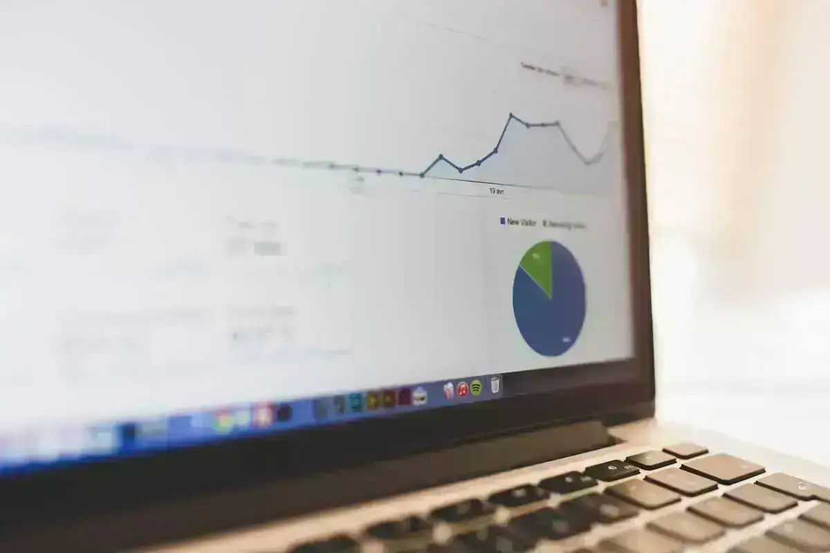 Laptop showing analytics dashboard with revenue and occupancy charts