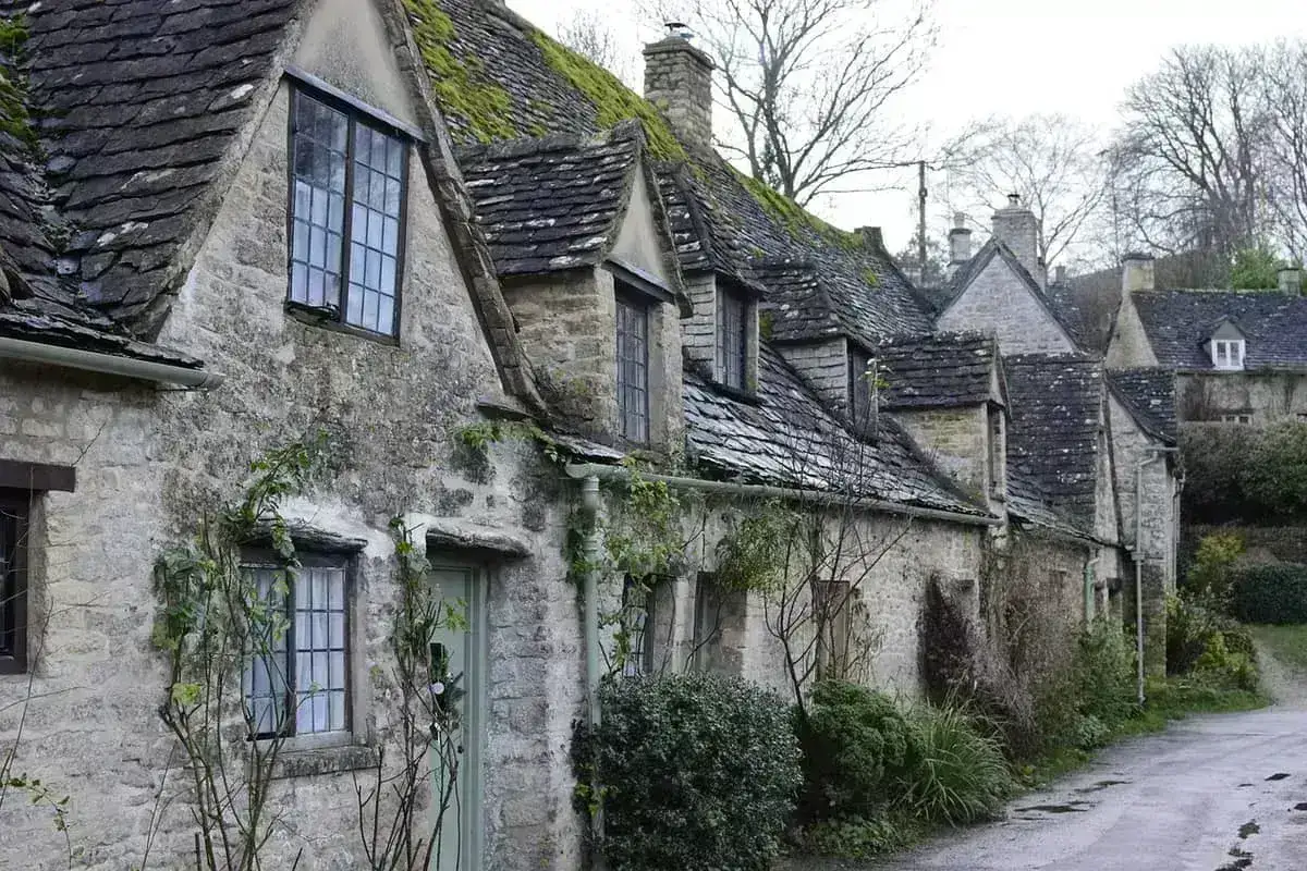 Happy holiday let owners outside their Dorset cottage